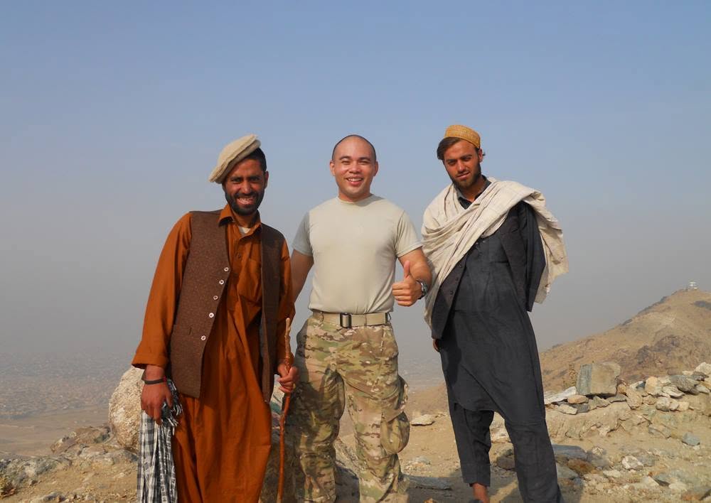 Peter J. Santos with two local men on a hilltop