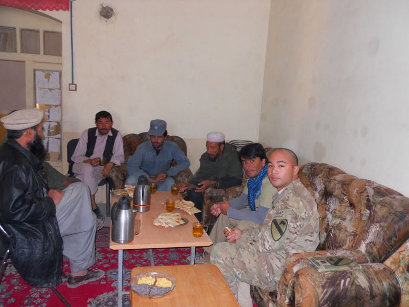 Peter J. Santos seated with Afghan village elders